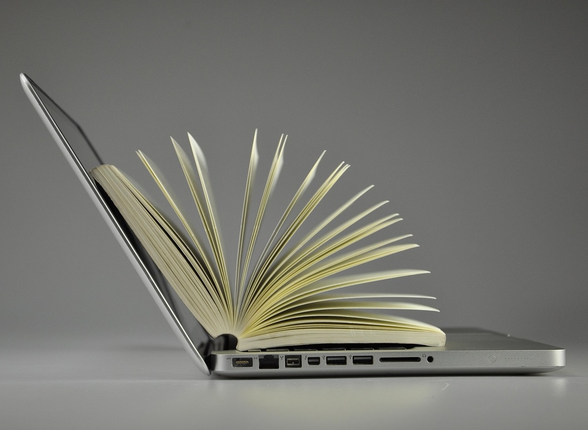 Open laptop with book inside